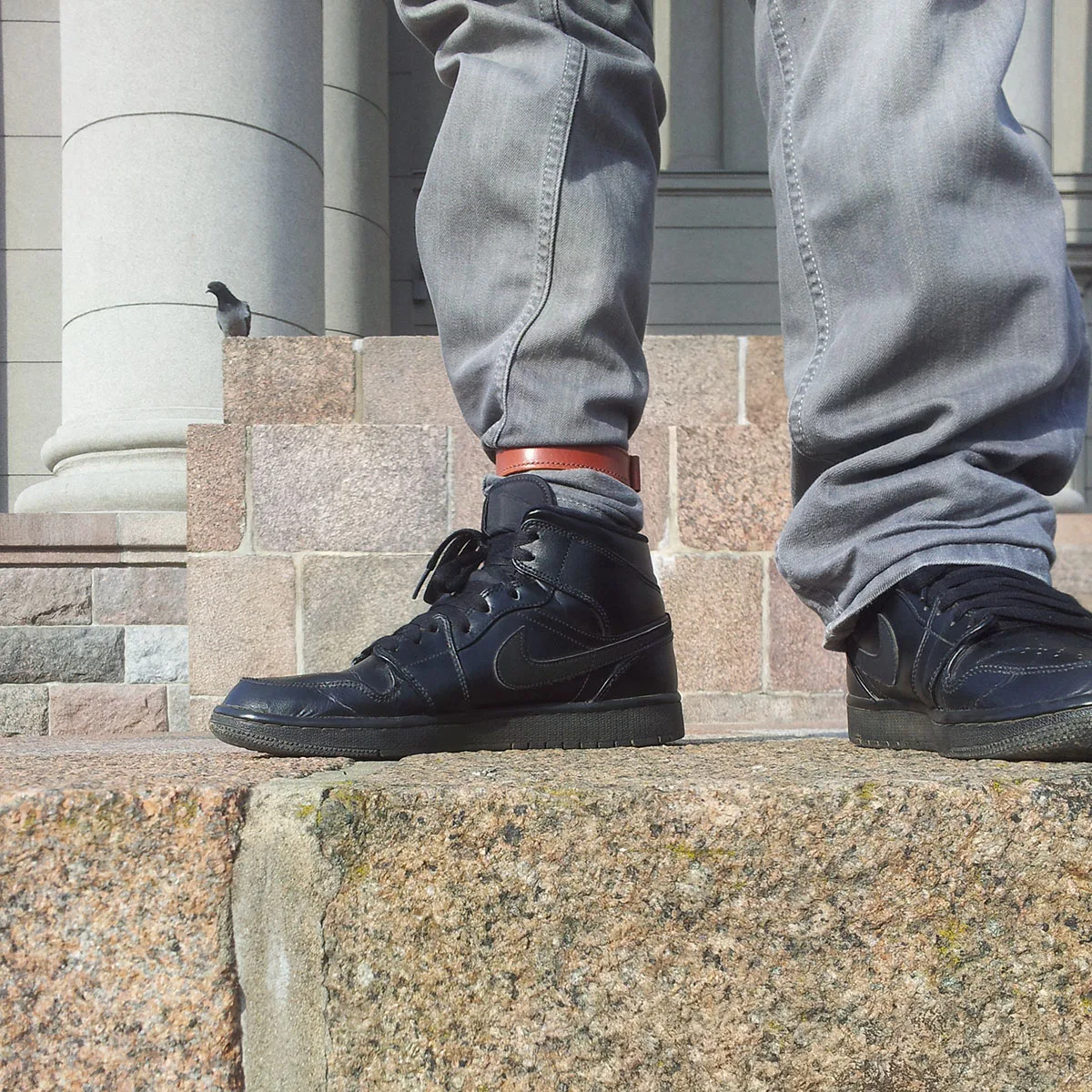 Urban commuter cyclist with leather trouser strap on pants leg