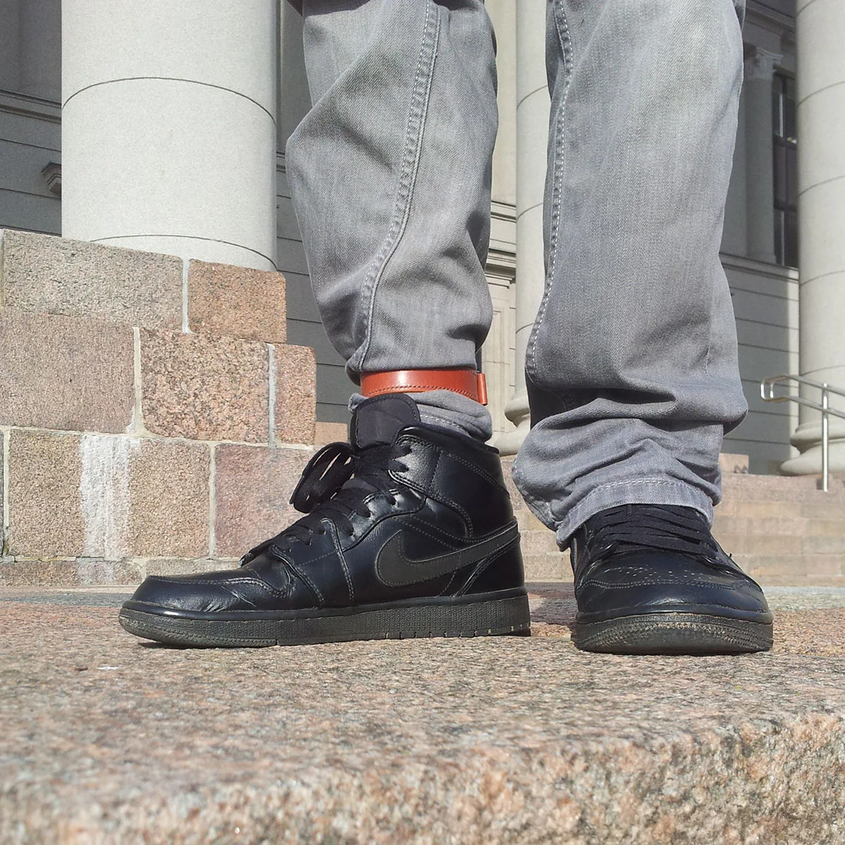 City commuter cyclist with leather trouser strap on pants leg