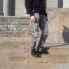Urban cyclist wearing leather trouser strap for commute
