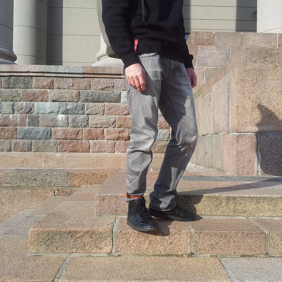 Urban cyclist wearing leather trouser strap for commute