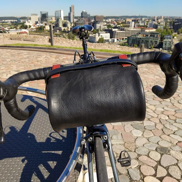 Leather handlebar bag on road bike in old town, Vilnius business district in the distance.