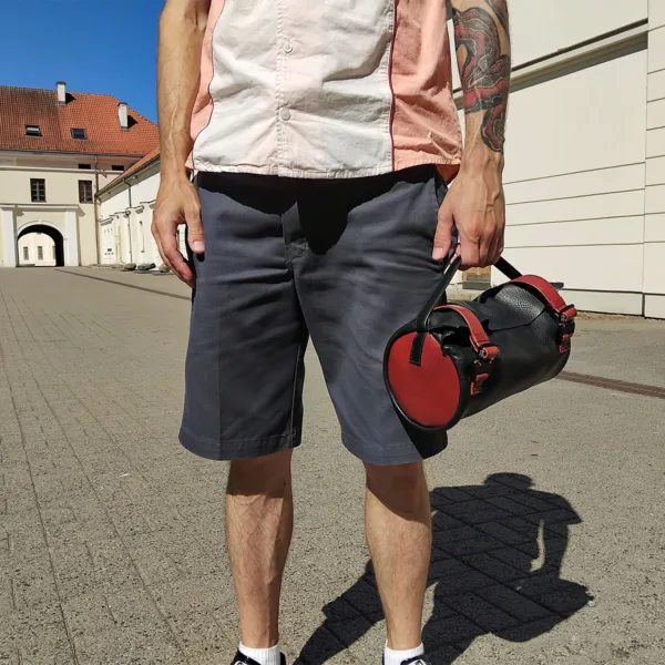 Cyclist holding handlebar bag in open palm