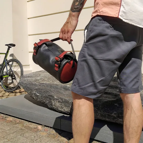 Bike commuter approaching road bike while carrying handlebar bag
