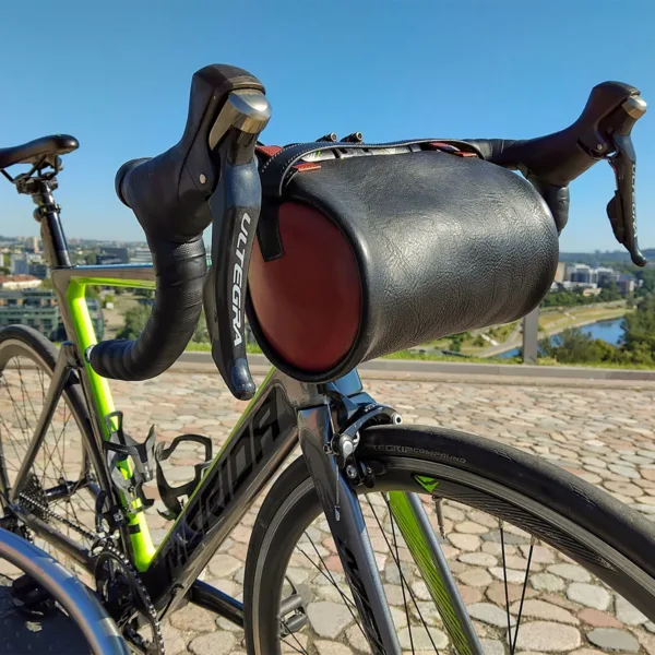 Road bike with leather handlebar bag in urban cityscape