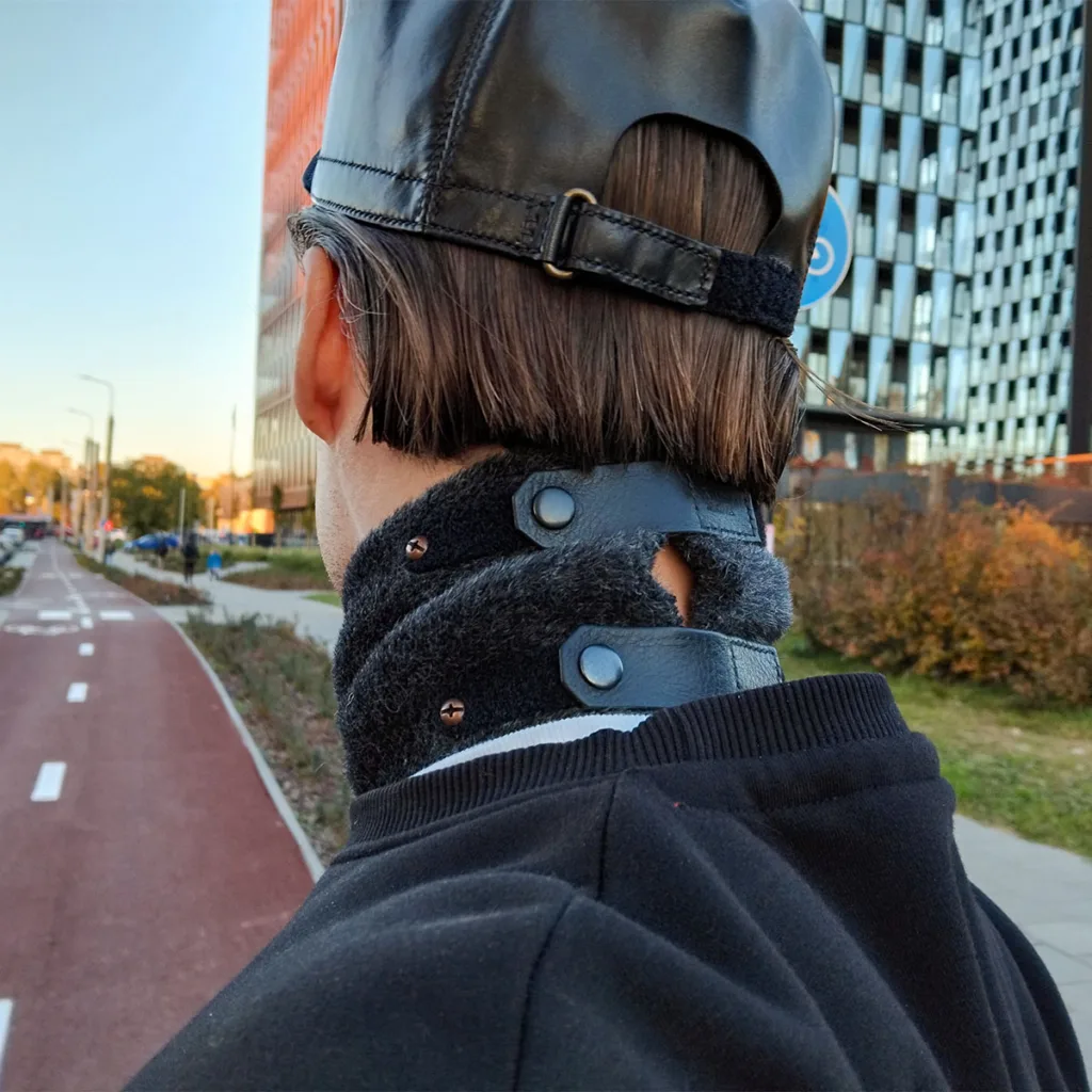 City cyclist on a red bike path in autumn wearing a wool scarf.